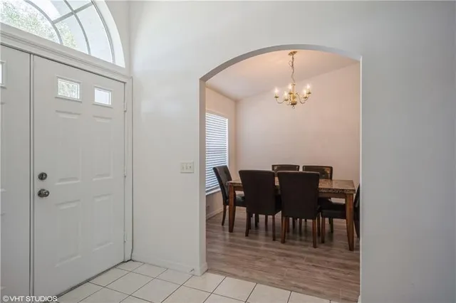 a view of a dining room with furniture and chandelier