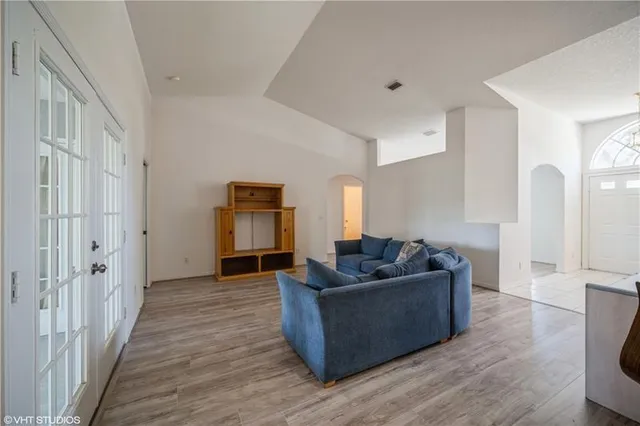 a living room with furniture and wooden floor