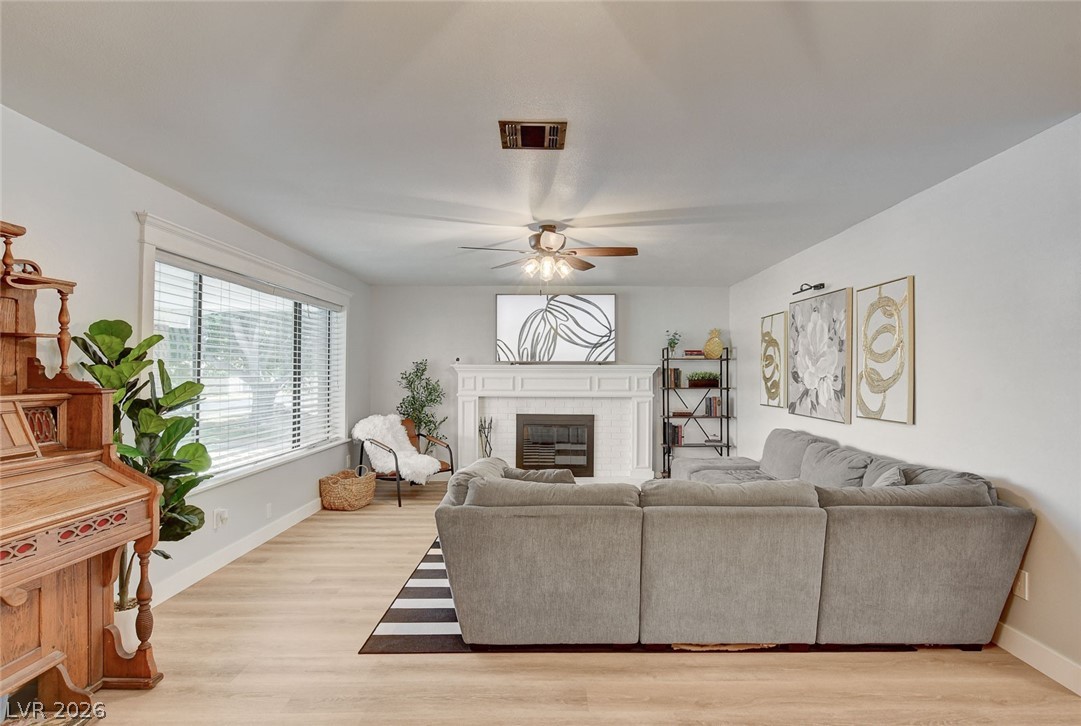 3765 Berkeley Street Logandale, NV 89021 - Photo 15 of 87 This inviting living area features a warm fireplace and abundant natural light.