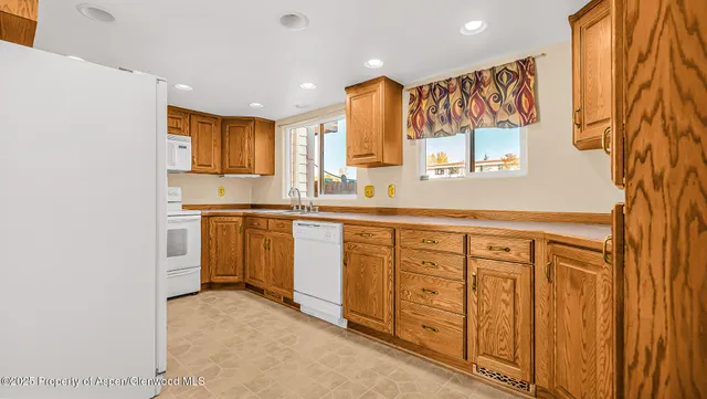 a kitchen with white cabinets and sink