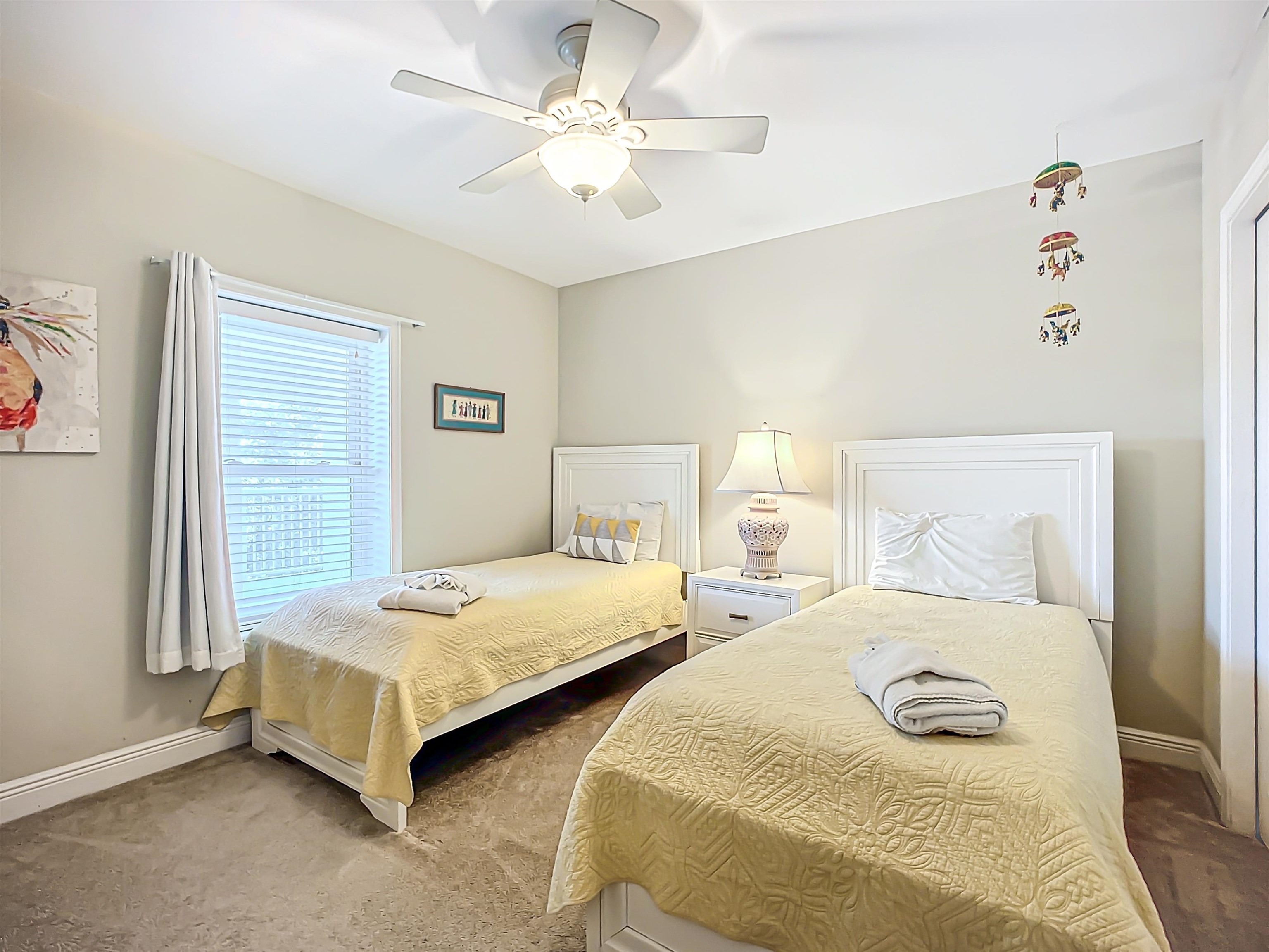 931 A1A Beach Boulevard, Unit 306 St. Augustine, FL 32080 - Photo 11 of 47 a bedroom with two beds and a chandelier