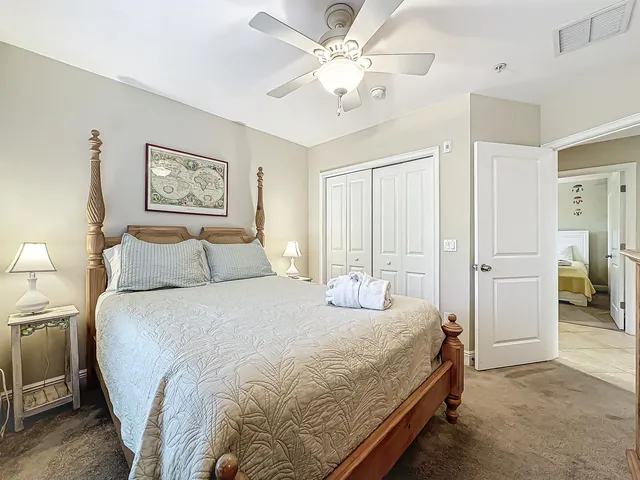 a bedroom with a bed a chandelier and a mirror