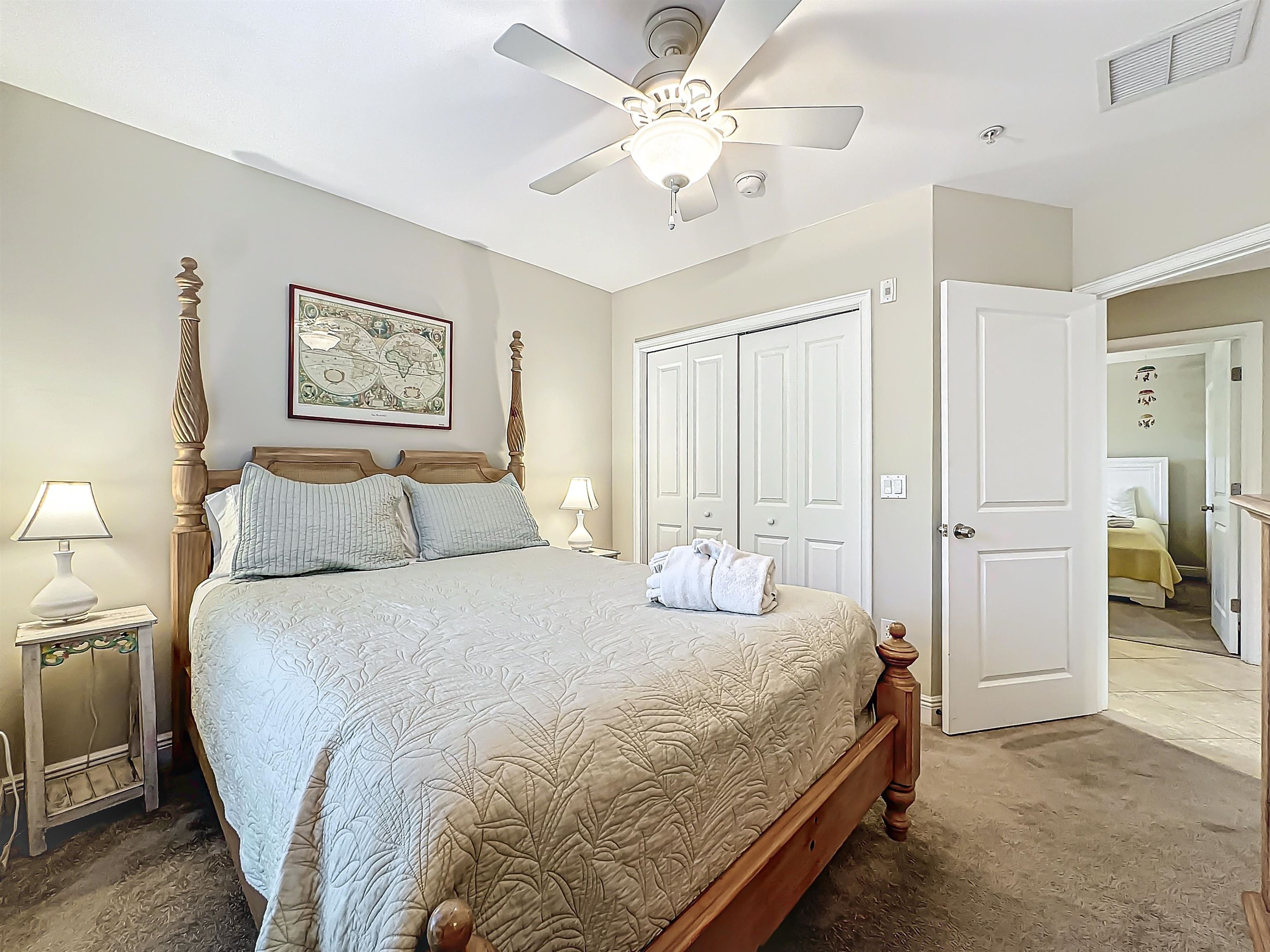 931 A1A Beach Boulevard, Unit 306 St. Augustine, FL 32080 - Photo 15 of 47 a bedroom with bed and a chandelier