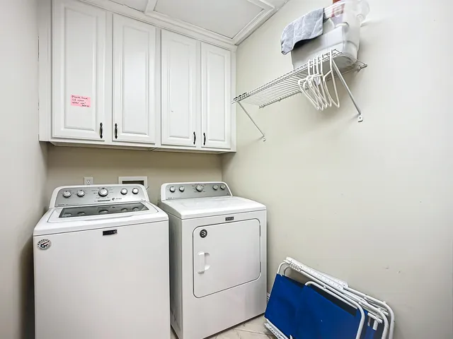 a kitchen with granite countertop a stove top oven microwave and refrigerator