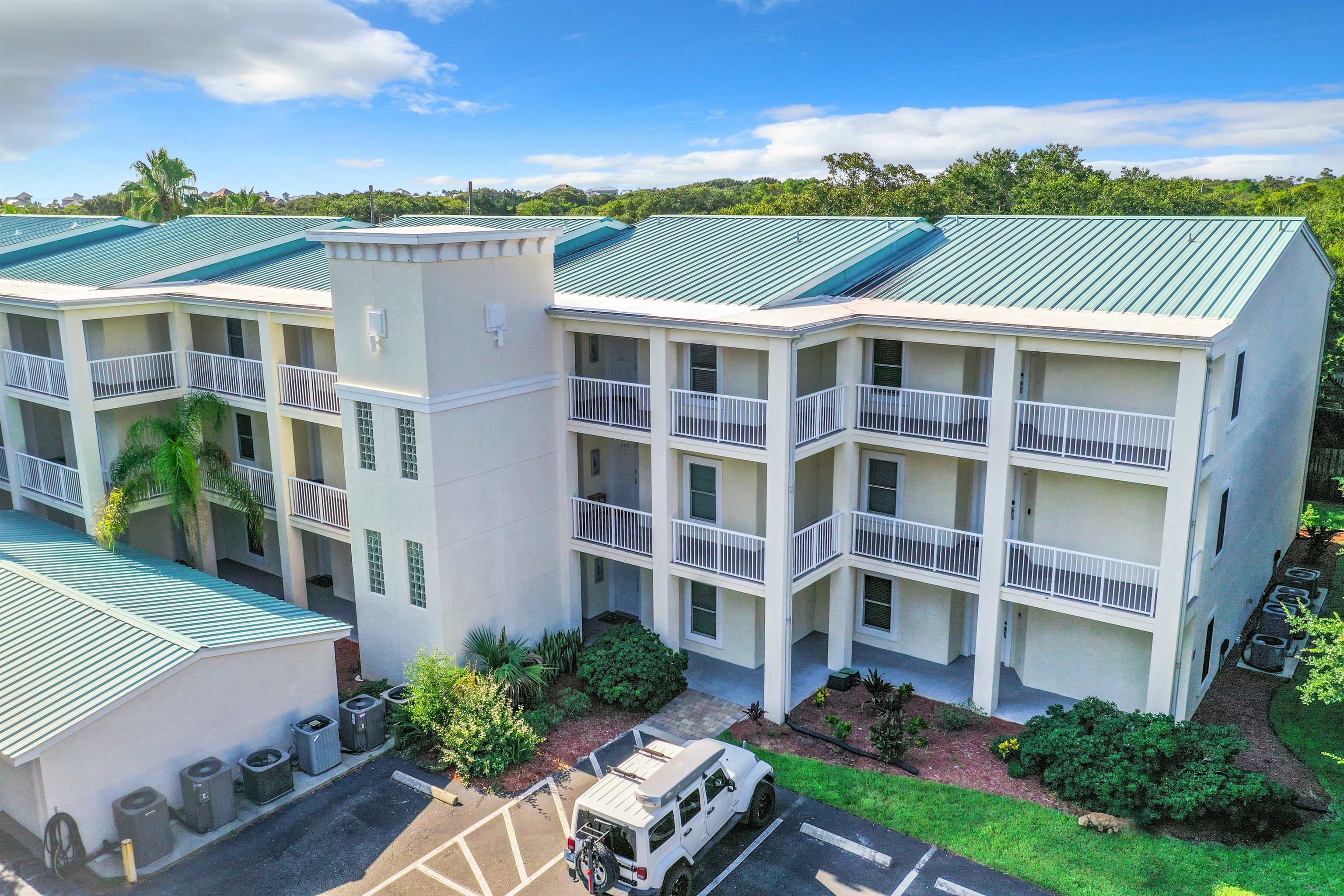 931 A1A Beach Boulevard, Unit 306 St. Augustine, FL 32080 - Photo 2 of 47 a view of a building with a garden