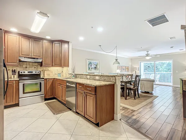 a kitchen with stainless steel appliances granite countertop a sink and cabinets