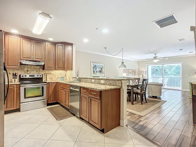 a kitchen with stainless steel appliances granite countertop a sink and cabinets