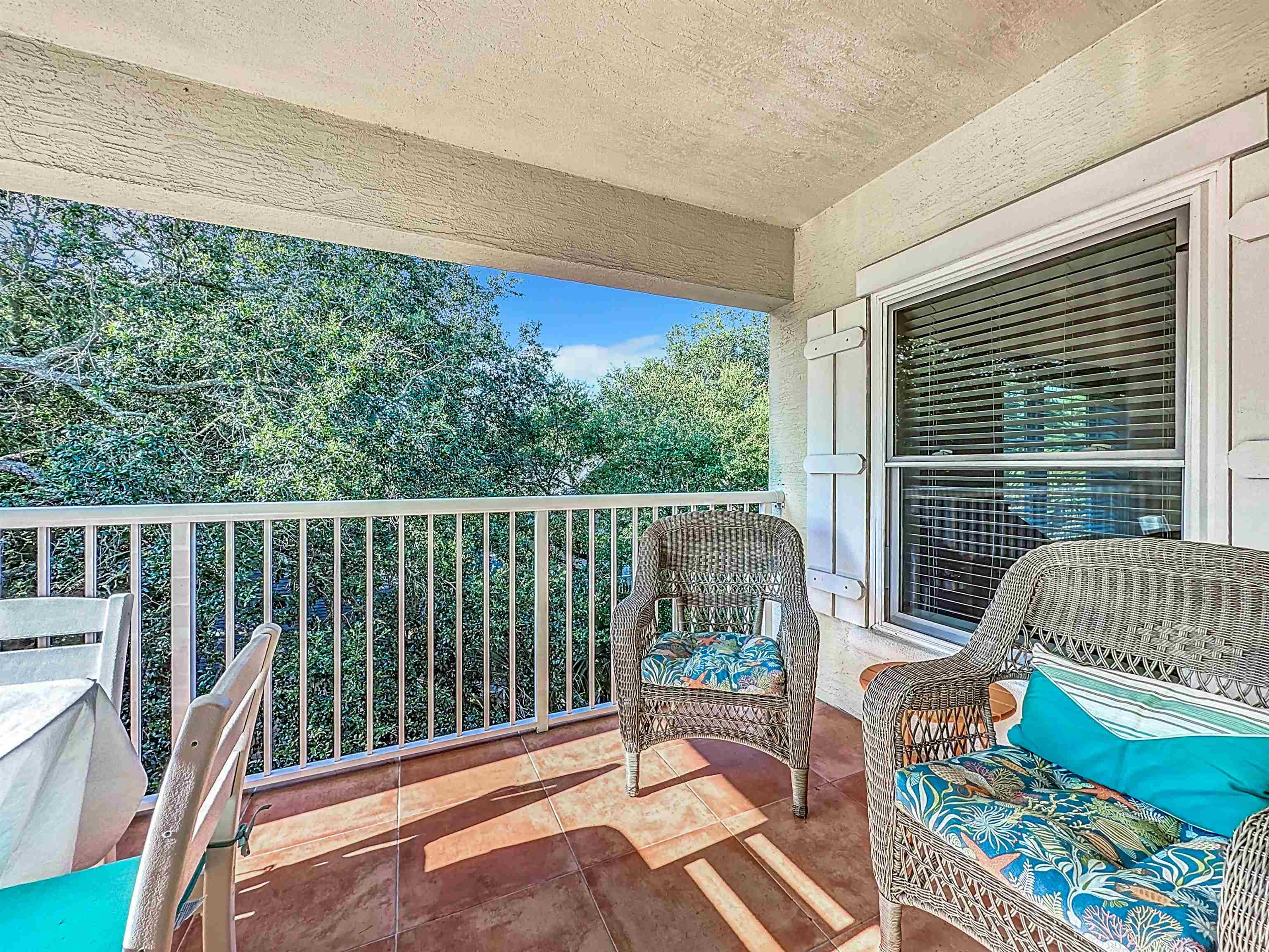 931 A1A Beach Boulevard, Unit 306 St. Augustine, FL 32080 - Photo 34 of 47 a balcony with chairs and wooden fence