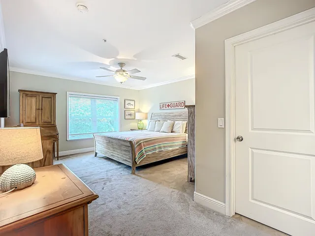 a bedroom with a large bed and a chandelier