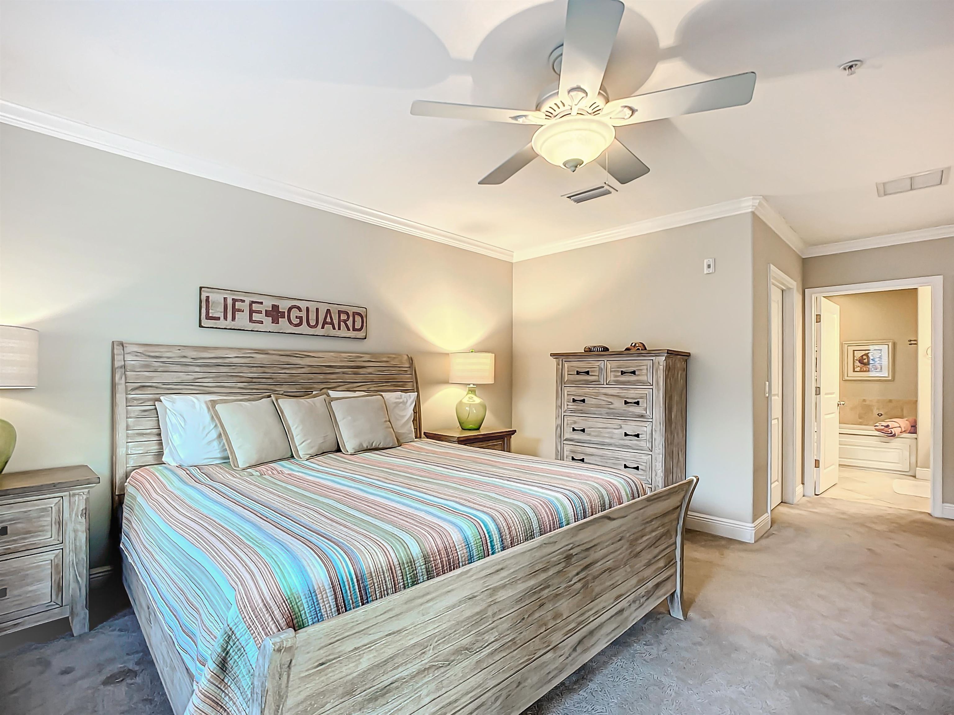 931 A1A Beach Boulevard, Unit 306 St. Augustine, FL 32080 - Photo 38 of 47 a bedroom with a large bed and a chandelier