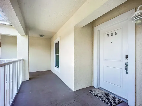 a view of a hallway with closet and wooden door