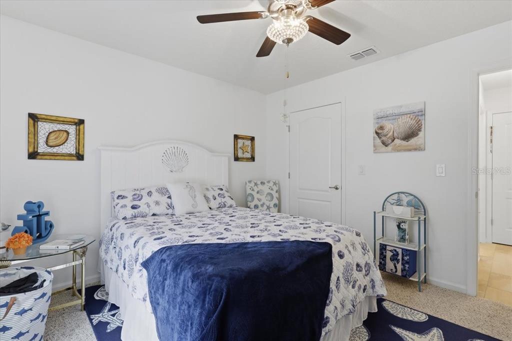 35 Birdie Way Bunnell, FL 32110 - Photo 38 of 57 a bedroom with a bed and a chandelier