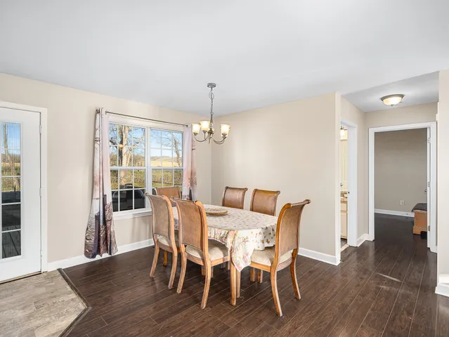 a view of a dining room with furniture wooden floor and chandelier