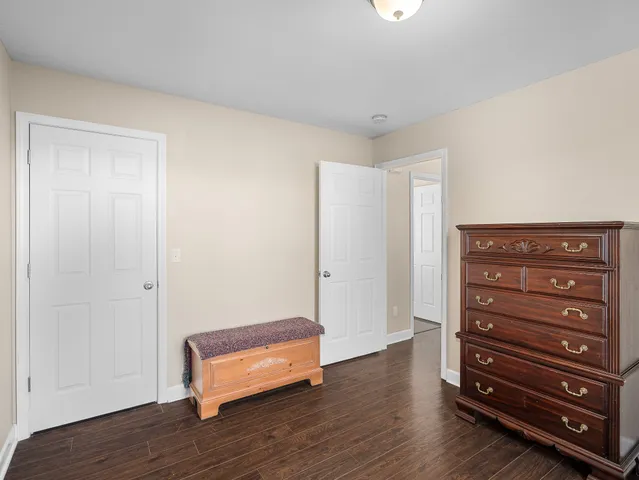 a view of room with furniture and wooden floor