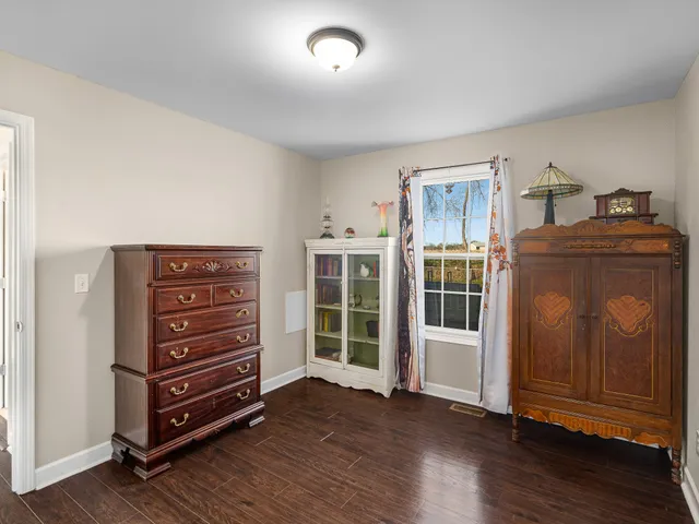 a view of room with furniture and wooden floor