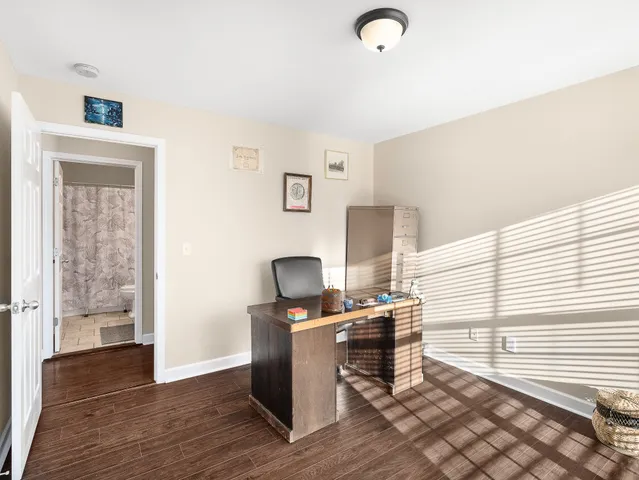 a view of a workspace with furniture and a window