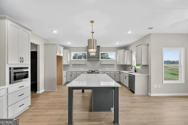 an empty room with windows and chandelier