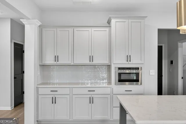 an empty room with a window and a ceiling fan