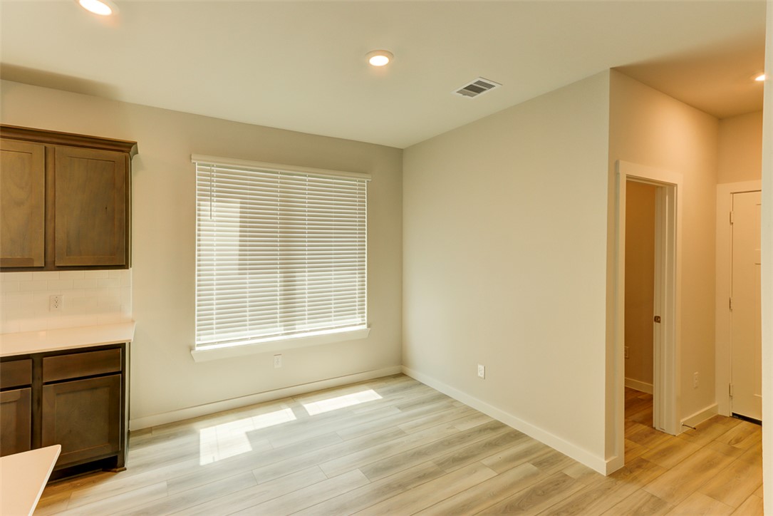 760 Double Mountain Road College Station, TX 77845 - Photo 9 of 26 a view of an empty room with wooden floor and a window