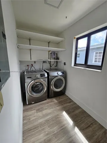 a utility room with sink dryer and washer