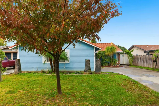 a backyard of a house with table and chairs