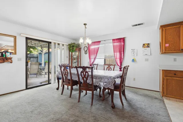 a dining room with furniture window and wooden floor