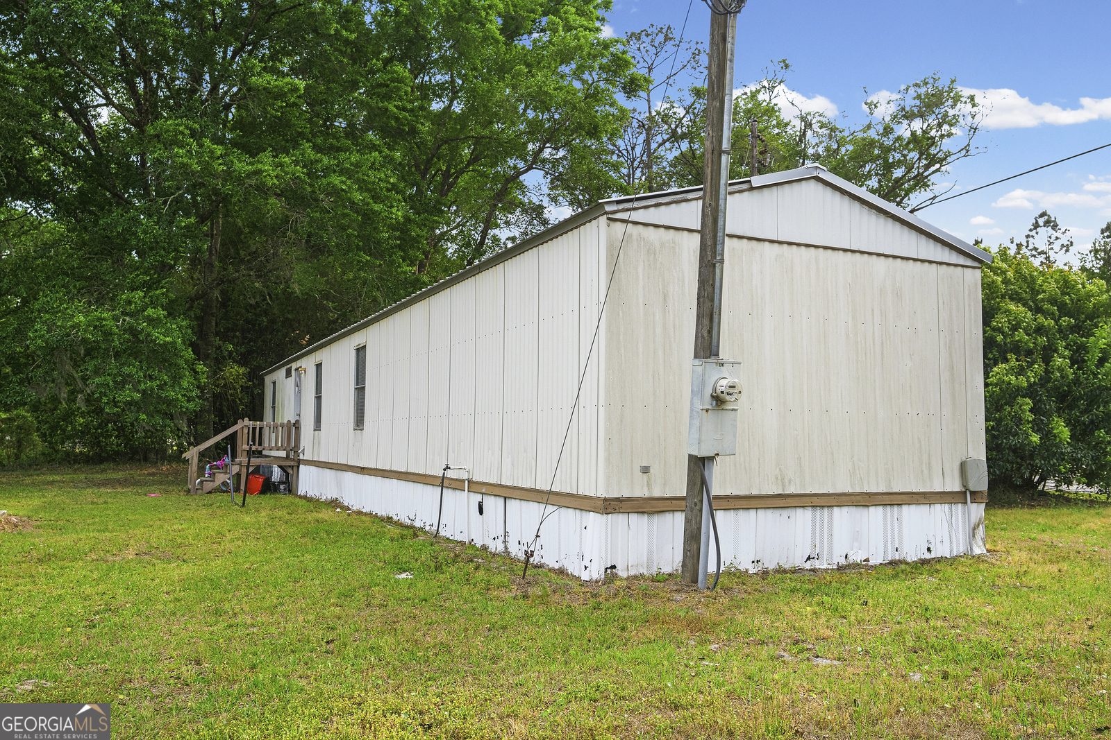 304 Cannon Street Nahunta, GA 31553 - Photo 2 of 51 a view of a backyard with potted plants and large tree