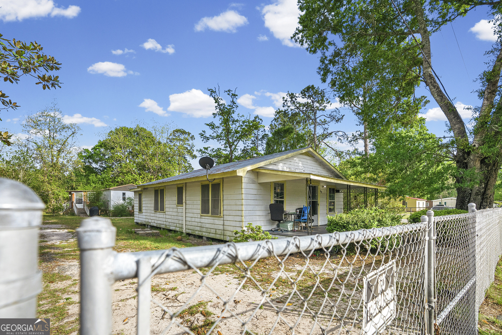 304 Cannon Street Nahunta, GA 31553 - Photo 22 of 51 a front view of a house with a yard and potted plants
