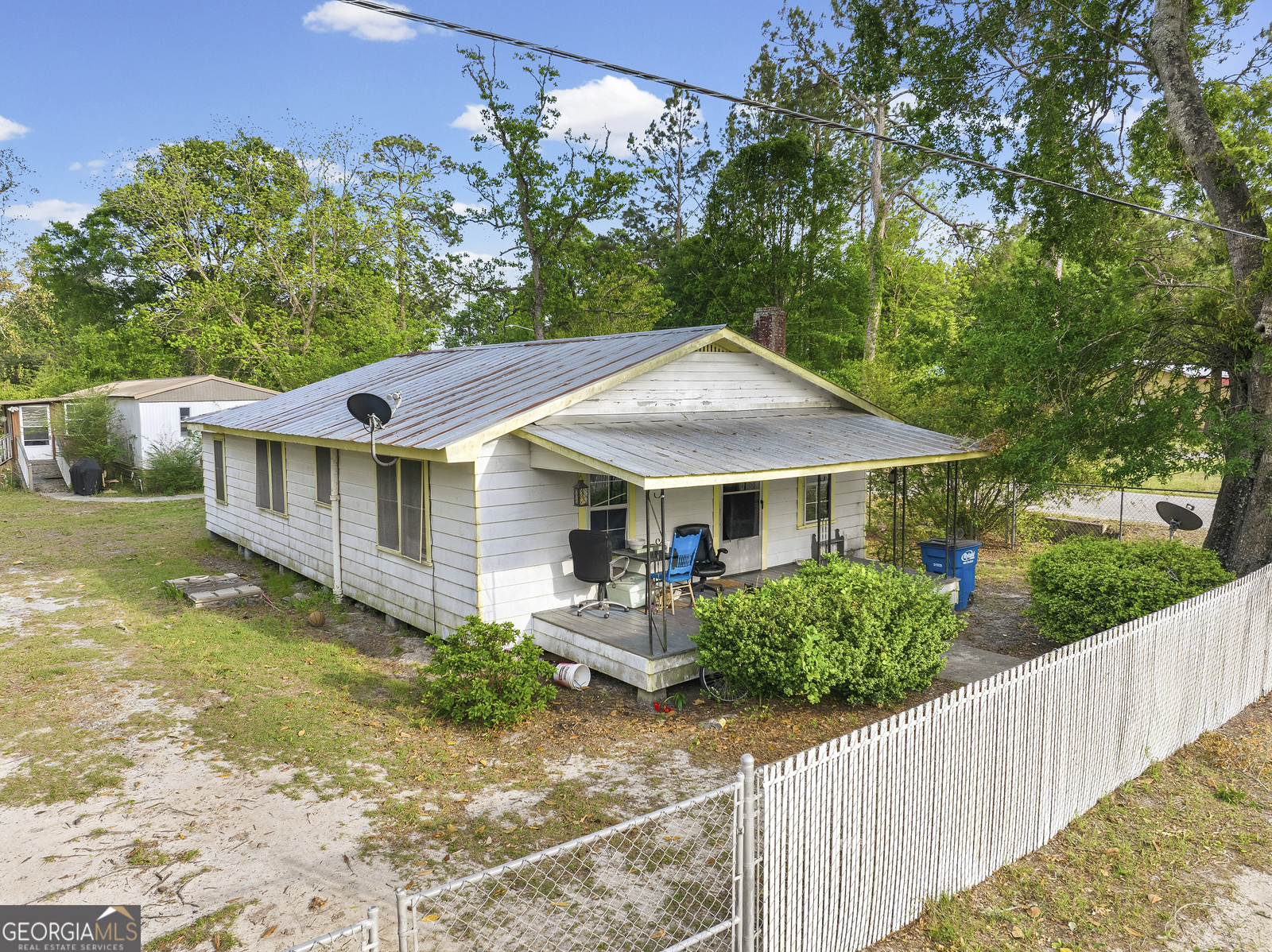 304 Cannon Street Nahunta, GA 31553 - Photo 27 of 51 a view of a house with wooden fence next to a yard