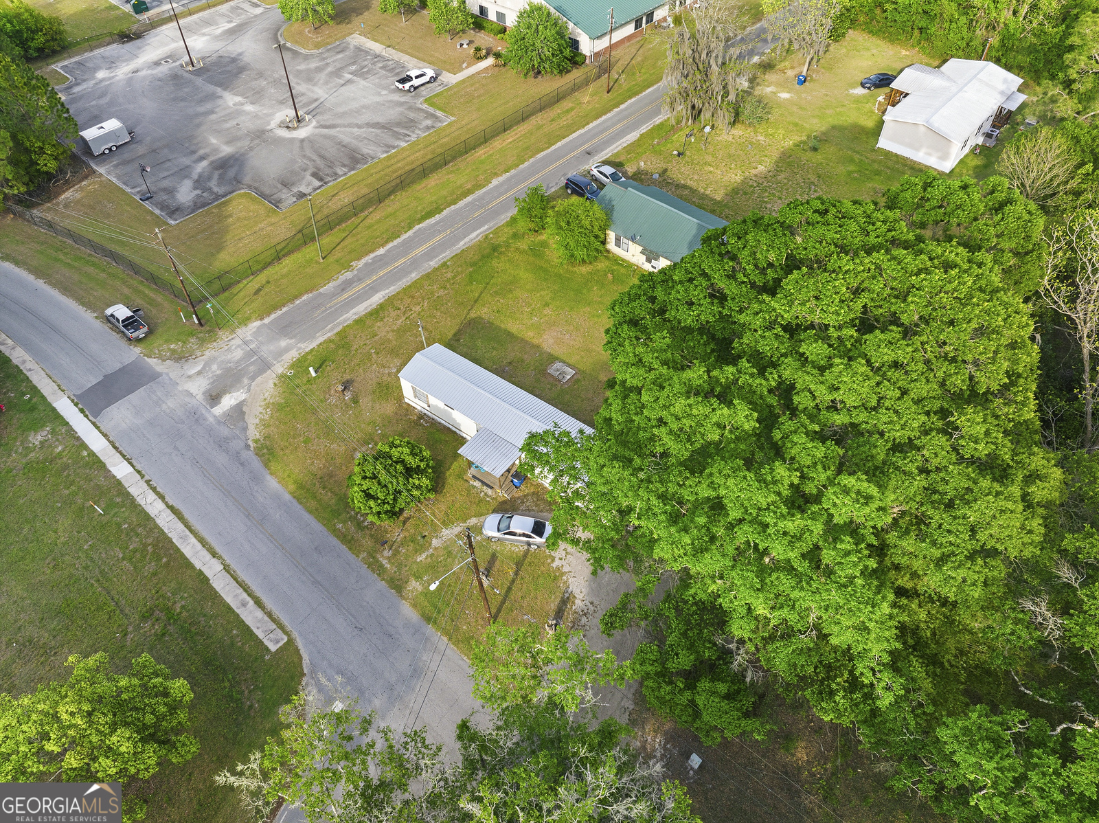 304 Cannon Street Nahunta, GA 31553 - Photo 4 of 51 an aerial view of a house with a yard and lake view