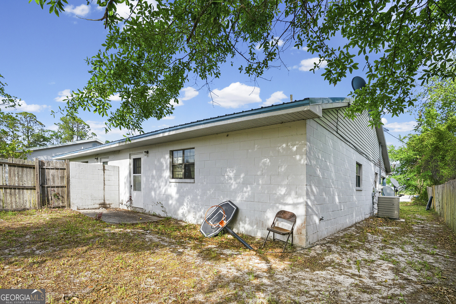 304 Cannon Street Nahunta, GA 31553 - Photo 7 of 51 a backyard of a house with table and chairs under an umbrella