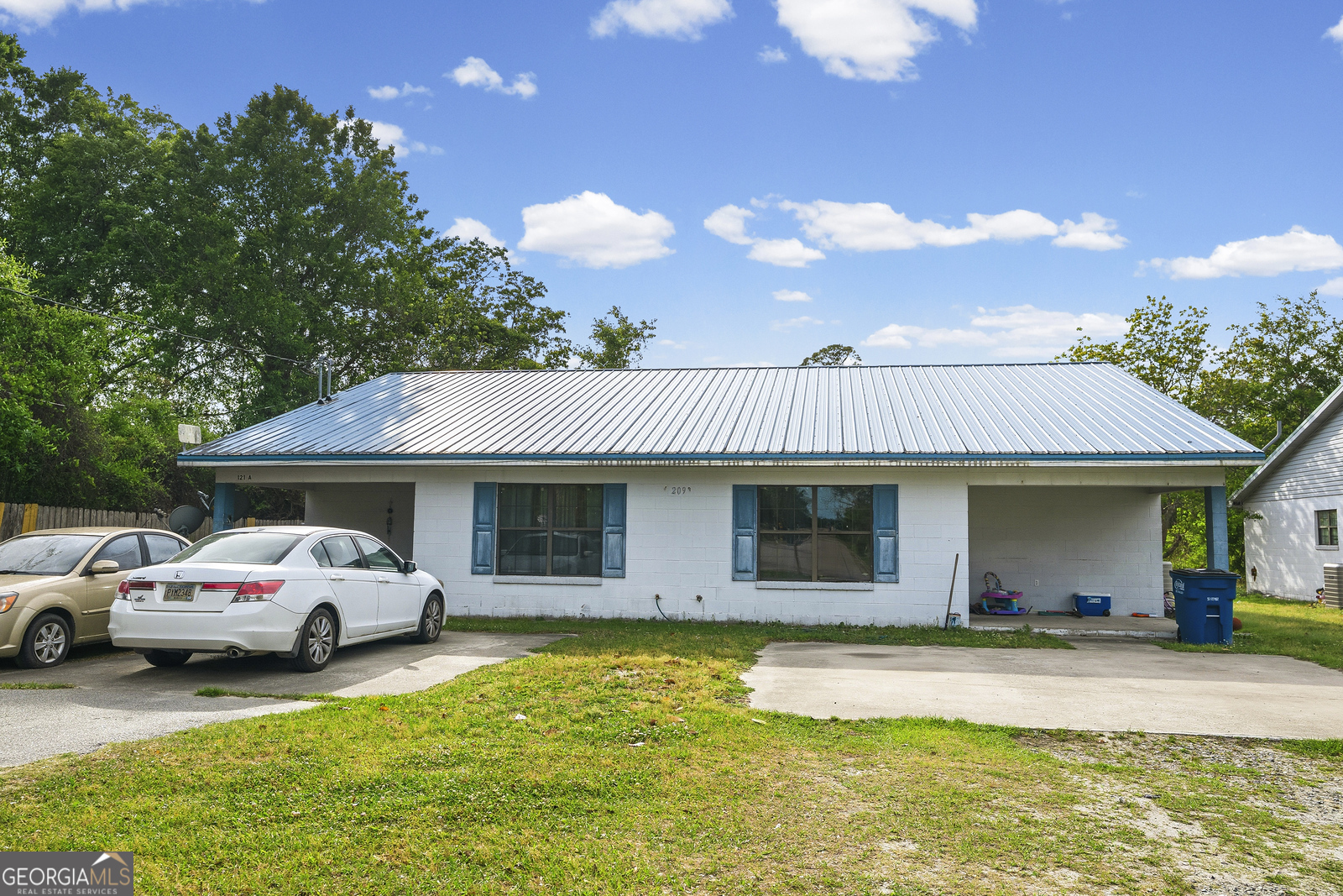 304 Cannon Street Nahunta, GA 31553 - Photo 9 of 51 a front view of a house with a garden and parking