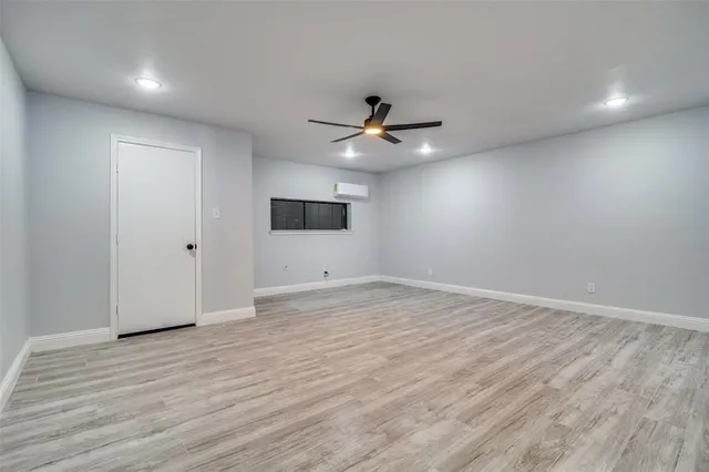 a view of an empty room with a ceiling fan