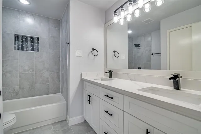 a bathroom with a tub sink and mirror