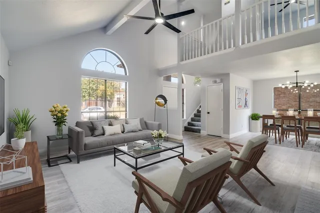 a living room with furniture dining table and a large window