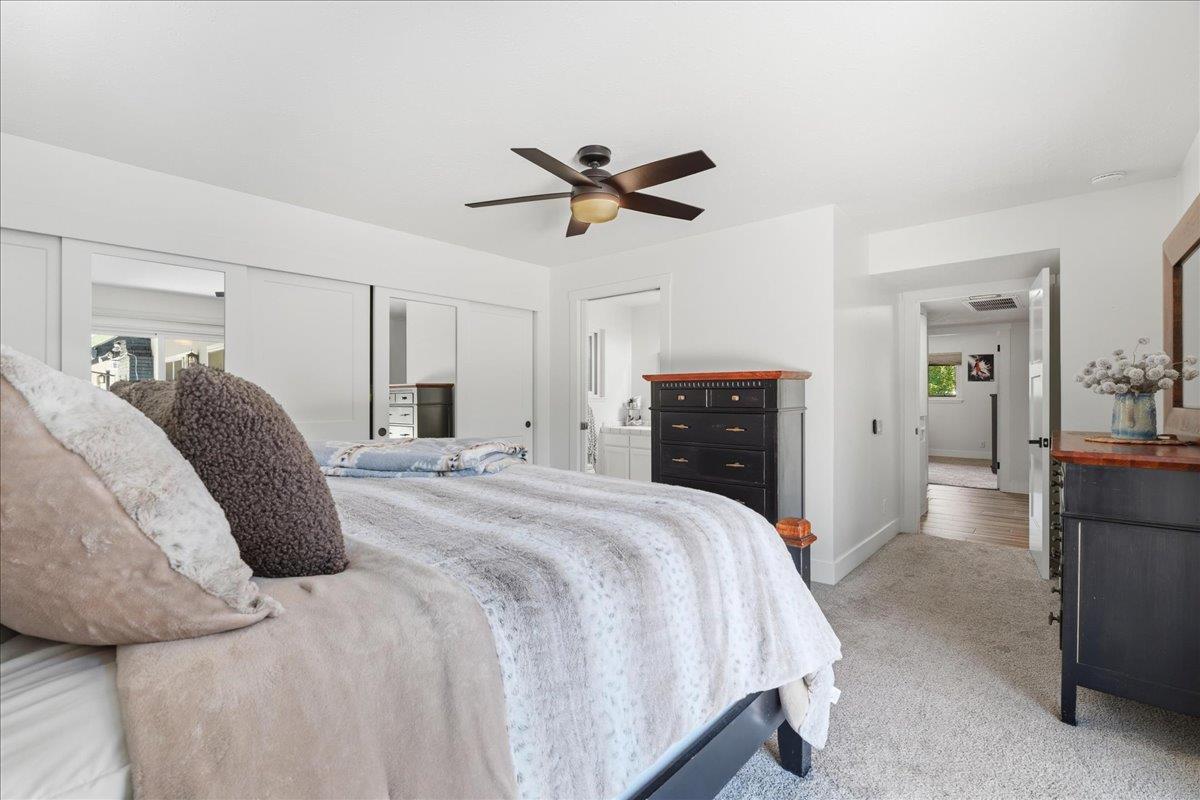 4849 Alexon Way Carmichael, CA 95608 - Photo 33 of 50 a spacious bedroom with a bed and a chandelier