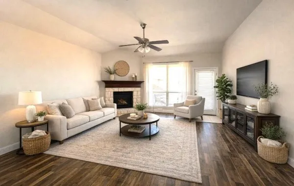 a living room with furniture a fireplace and a flat screen tv