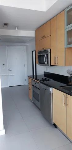 a kitchen with a stove and a refrigerator