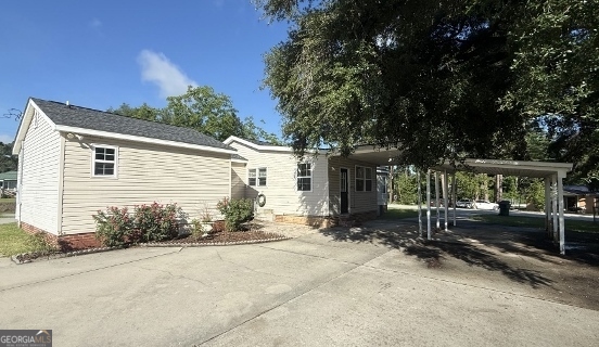 451 Lambs Bridge Road Swainsboro, GA 30401 - Photo 2 of 23 a view of a house with a yard