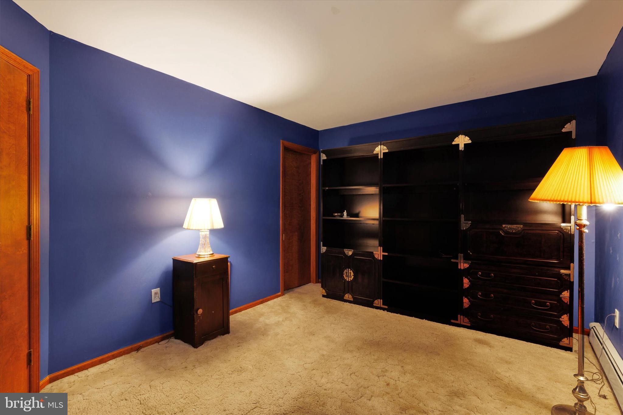 523 River Road Delta, PA 17314 - Photo 13 of 27 a bedroom with a bed and a lamp on dresser