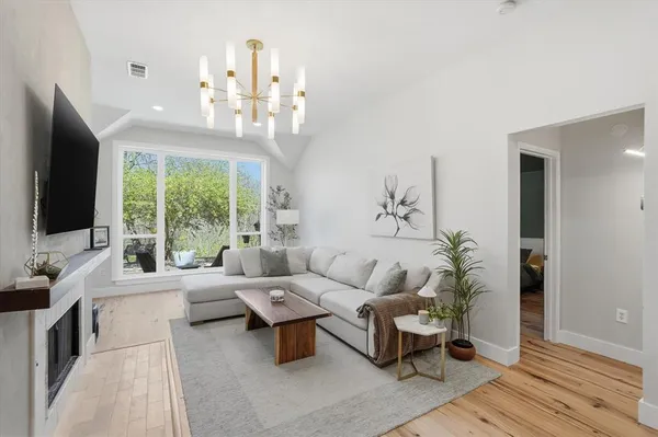 a living room with patio furniture and a flat screen tv