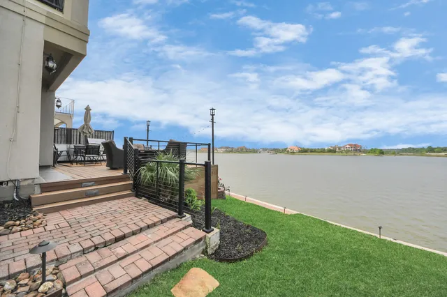 a view of a balcony with wooden floor and outdoor seating