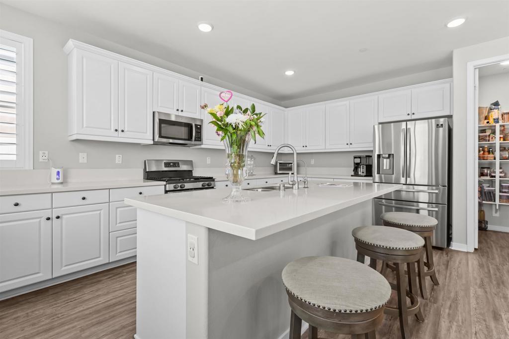 29809 Gypsy Vanner Way Menifee, CA 92584 - Photo 17 of 45 a kitchen with a sink cabinets and refrigerator