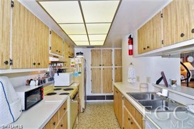 978 Sand Castle Road Sanibel, FL 33957 - Photo 4 of 10 a kitchen that has a sink and a stove