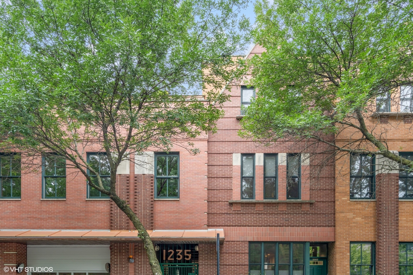 1235 West George Street, Unit 215 Chicago, IL 60657 - Photo 1 of 25 a front view of a house with a tree