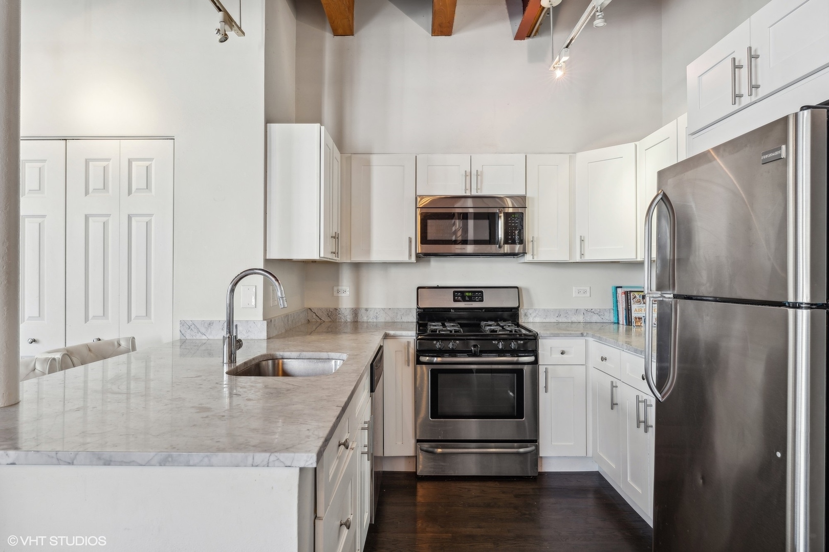 1235 West George Street, Unit 215 Chicago, IL 60657 - Photo 11 of 25 a kitchen with stainless steel appliances granite countertop a refrigerator stove and sink
