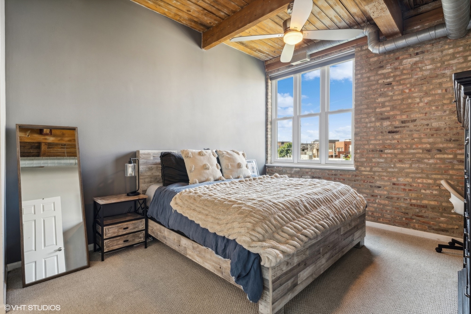 1235 West George Street, Unit 215 Chicago, IL 60657 - Photo 13 of 25 a bed sitting in a bedroom next to a window