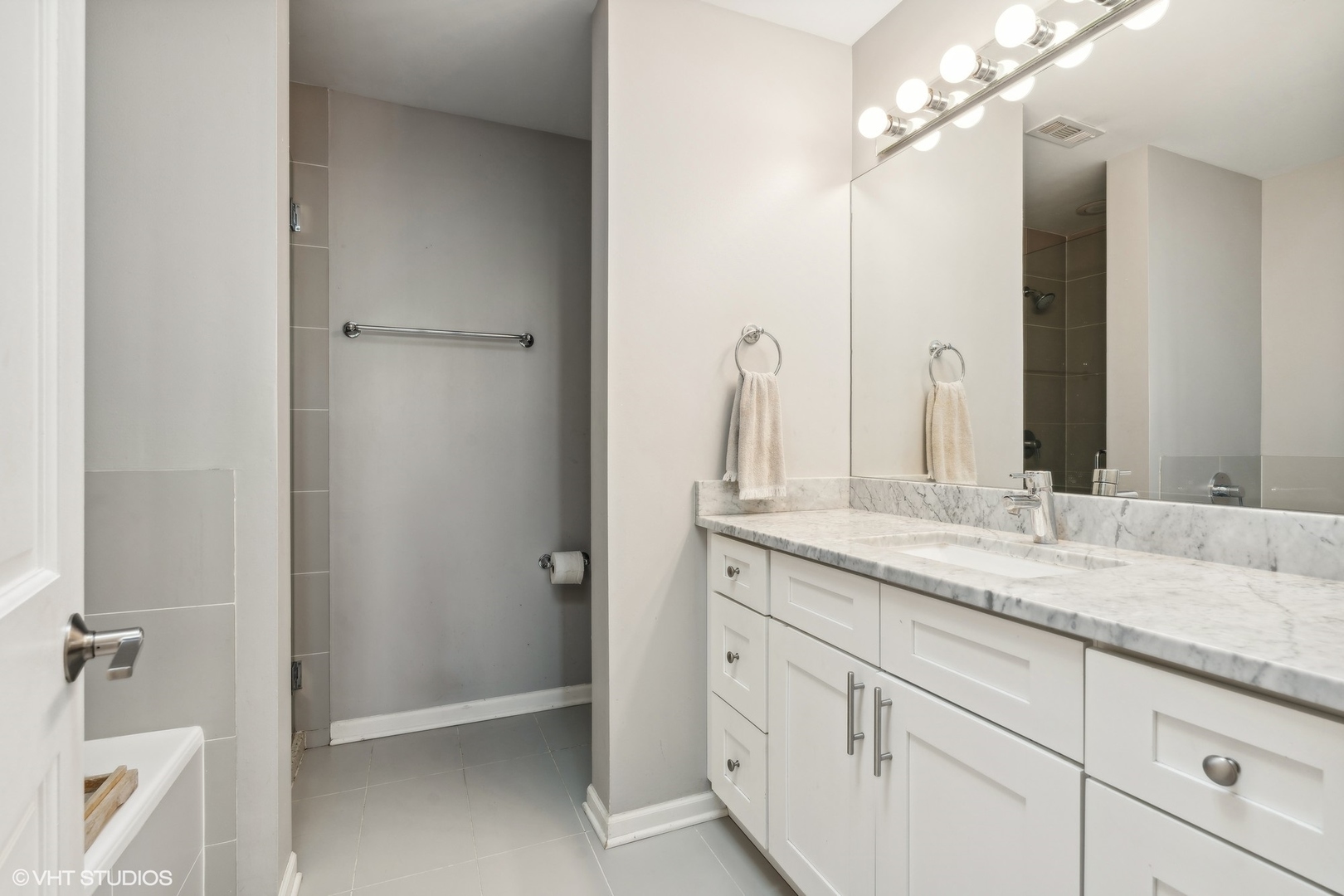 1235 West George Street, Unit 215 Chicago, IL 60657 - Photo 16 of 25 a bathroom with a granite countertop sink and a mirror