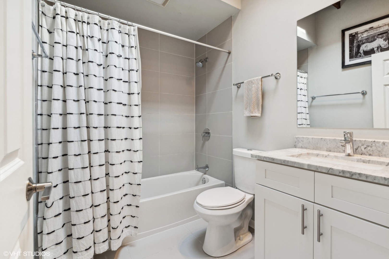 1235 West George Street, Unit 215 Chicago, IL 60657 - Photo 20 of 25 a bathroom with a shower curtain sink and toilet