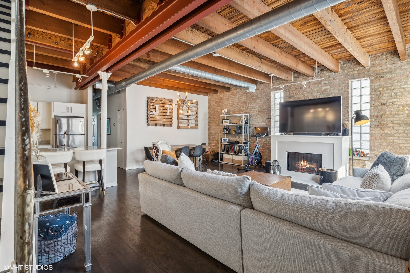 1235 West George Street, Unit 215 Chicago, IL 60657 - Photo 3 of 25 a living room with furniture a fireplace and a flat screen tv